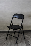Black padded folding chair.