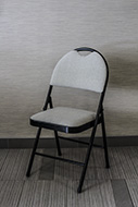 Cream padded folding chair.