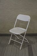 White padded folding chair.